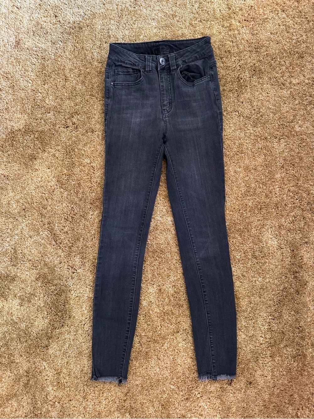 Black high-waisted Rue 21 skinny jeans with frayed hem; good condition